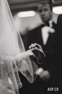 Putting the wedding ring on captured on authentic Ilford DELTA 3200 film by Arnold Szmerling. This manifestation highlights the organic grain and timeless soul of the Visual Life Collection.