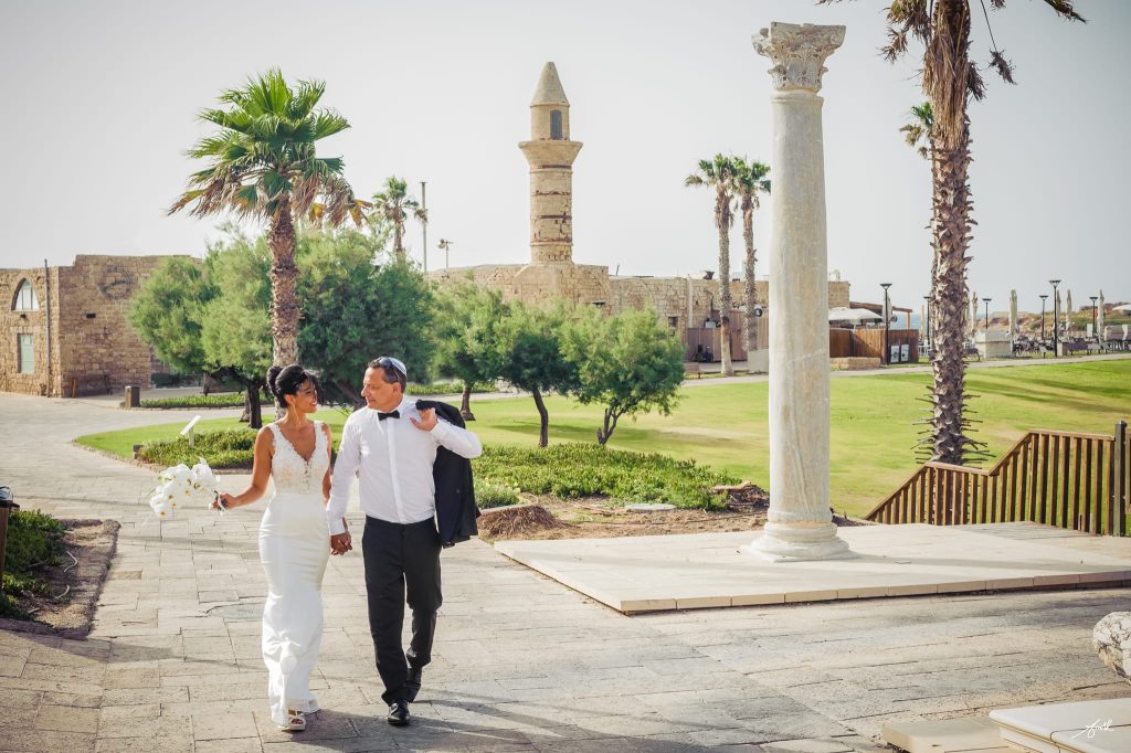 Architectural historic Caesarea perspective of a luxury wedding ceremony captured as iconic wedding photography by Arnold Szmerling, manifesting the enduring soul of the couple for the Visual Life Collection.
