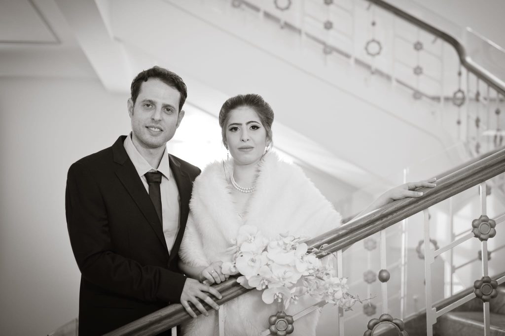 A classic 20's glamour style of the bride and groom featuring the art decor grand stair case captured as a fine art manifestation by Arnold Szmerling during an exclusive collaboration with the King David Jerusalem for the Visual Life Collection.