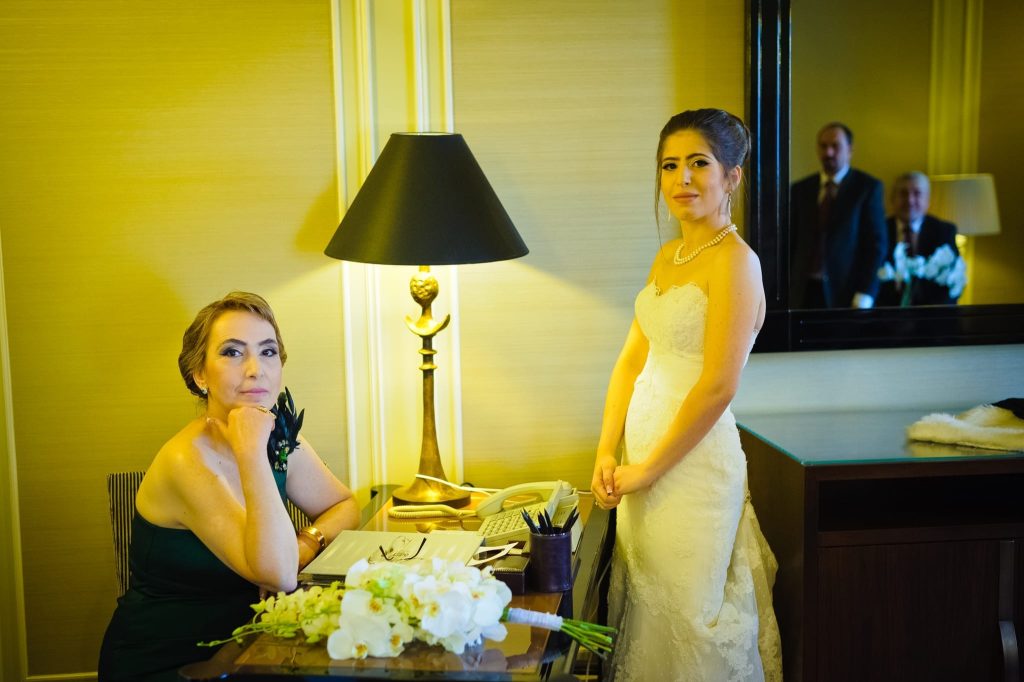 A classic stylized portrait of bride and mother with father and brother seen the mirror captured as a fine art manifestation by Arnold Szmerling during an exclusive collaboration with the King David Jerusalem for the Visual Life Collection.