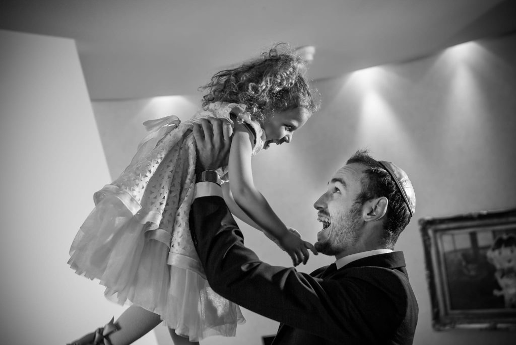 A father lifting is daughter up in the air while in the presidential suite captured as a fine art manifestation by Arnold Szmerling during an exclusive collaboration with the King David Jerusalem for the Visual Life Collection.
