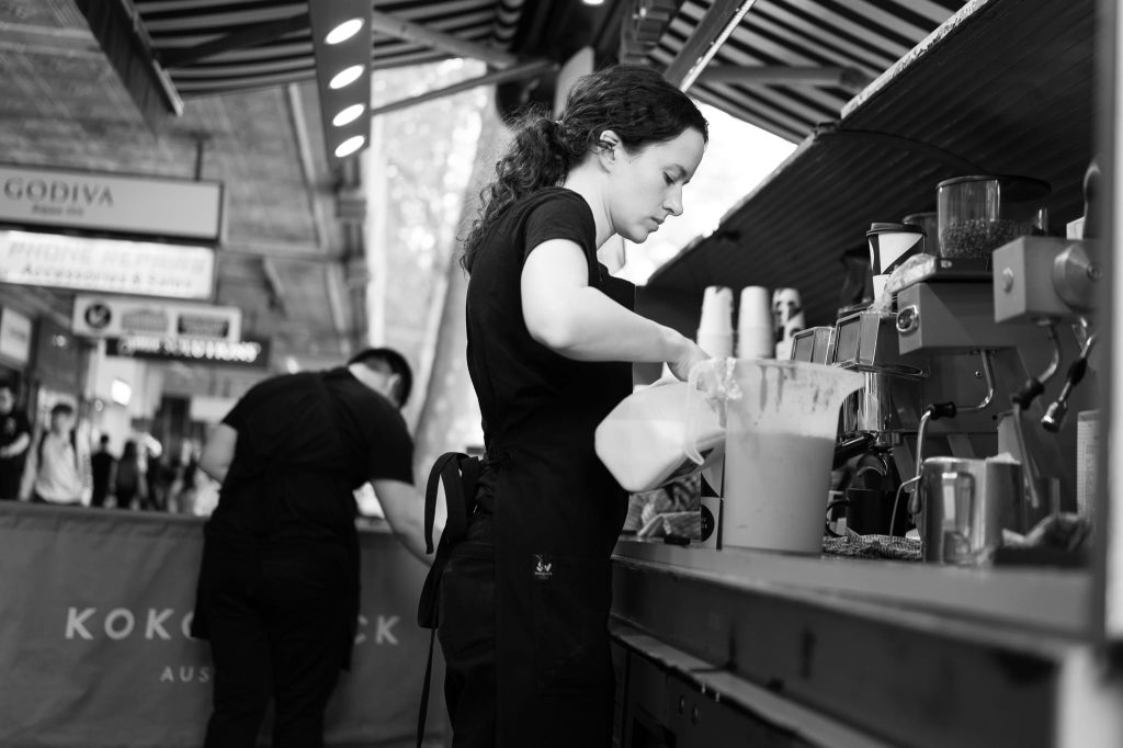 The young barrister girl in a street stall, a work of passion by Arnold Szmerling captured in Black and White during his Leica Q3 street photography experience.