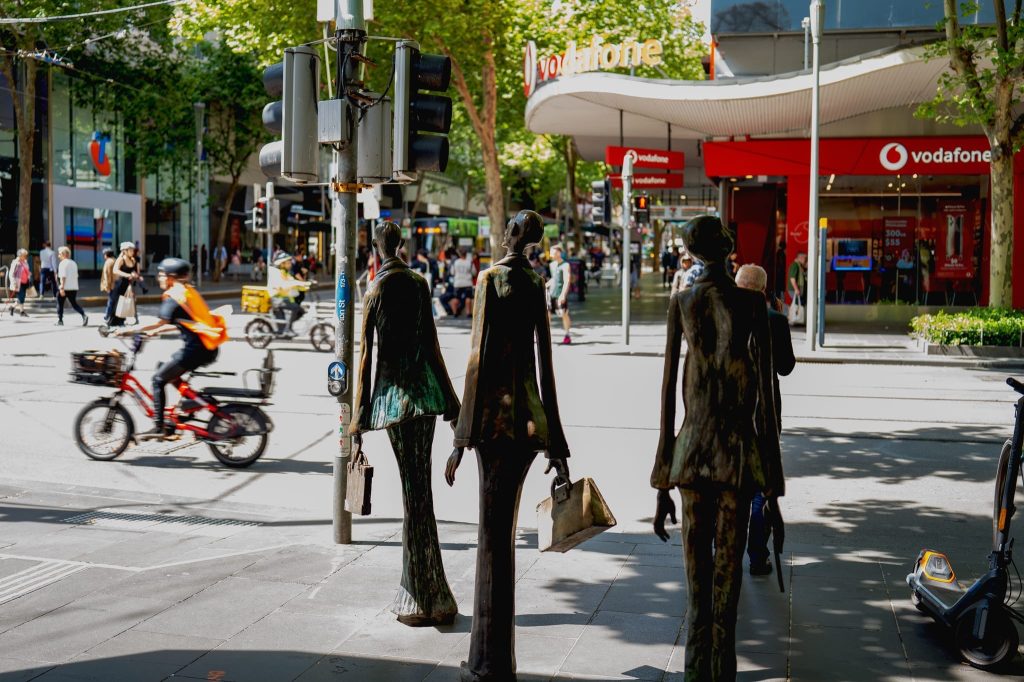 The three copper shopper statues in Melbourne , a work of passion by Arnold Szmerling captured during his Leica Q3 street photography experience.