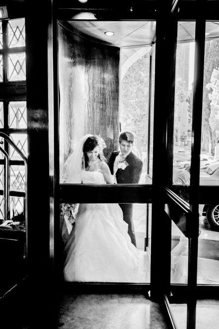 A bride and groom enter the rotating doors in the entrance captured as a fine art manifestation by Arnold Szmerling during an exclusive collaboration with the King David Jerusalem for the Visual Life Collection.